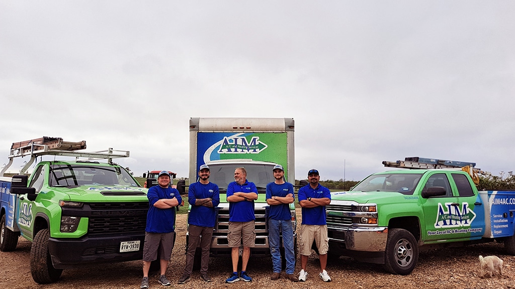 aim a/c and heating services team with their work vehicles