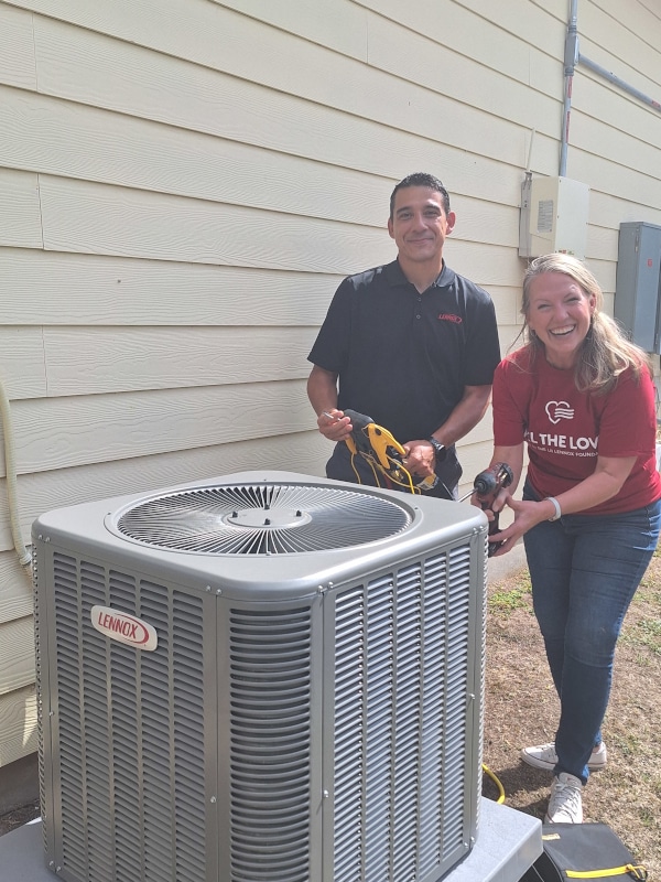 aim technician with a lennox representative installing a new hvac unit for the lennox feel the love contest winner