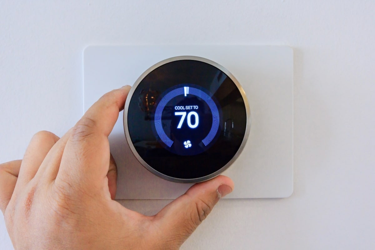 handing adjusting a smart thermostat to a cooler temperature